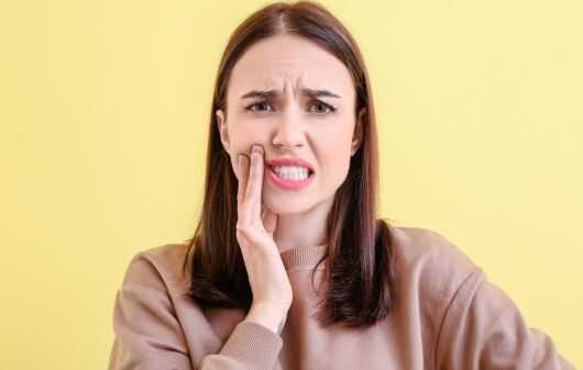 Young Woman Suffering from Tooth Ache