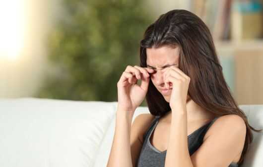 Girl suffering itching scratching eyes at home